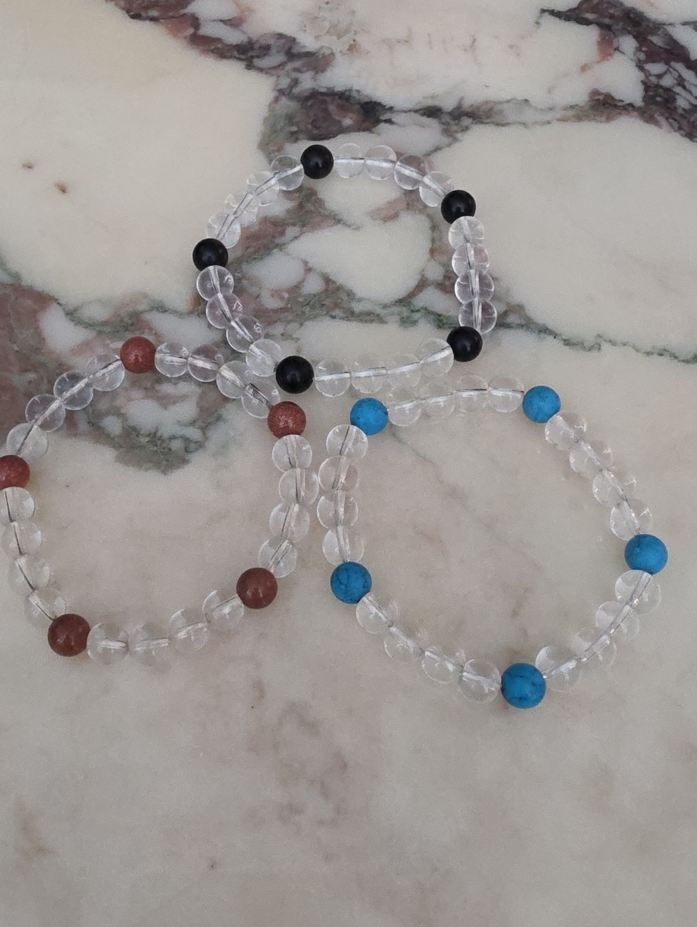 Clear Bead Stretch Bracelet with Blue, Black, and Brown Accent Beads